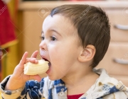 Boy 2 years old eating banana