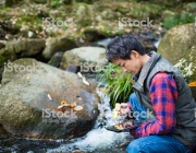 A scientist or researcher testing water quality with a pH meter