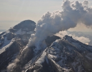 Summit crater, active lava dome, and steam plume of Redoubt volcano, May 8, 2009. View is toward the southeast.